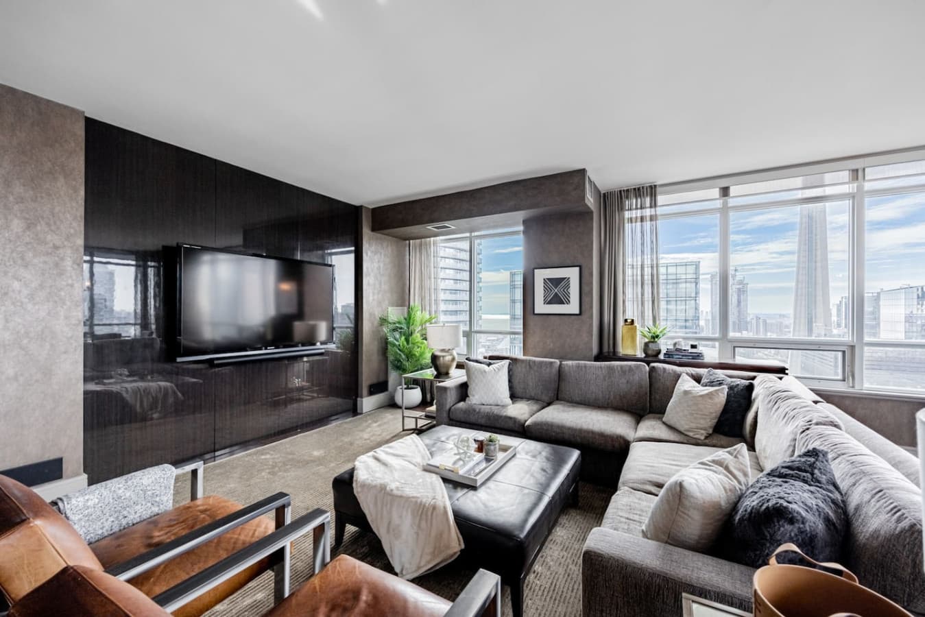 Living room of the downtown Toronto penthouse with floor-to-ceiling skyline views